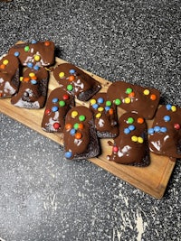 chocolate brownies with sprinkles on a wooden cutting board