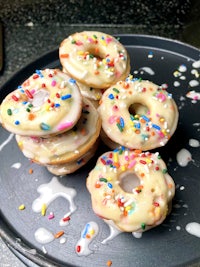 a plate of donuts with sprinkles on it