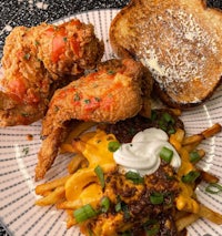 a plate with fried chicken, fries and ketchup